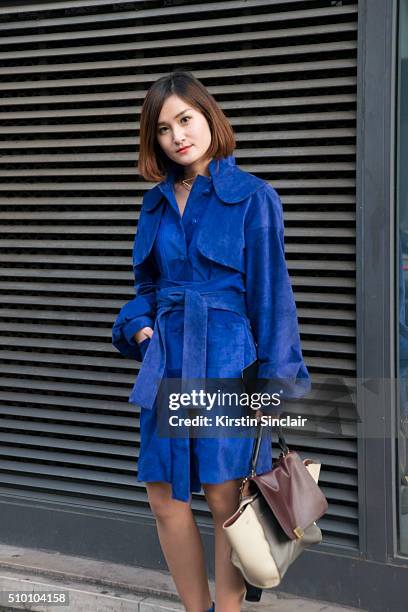 Fashion blogger Miu Pham wears a Xuan-Thu Nguyen coat, and a Celine bag on day 3 of Paris Haute Couture Fashion Week Spring/Summer 2016, on January...