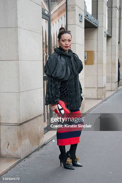 Head hunter and fashion blogger Thythu Nguyen wears a Xuan-Thu Nguyen jacket, Sonia Rykiel skirt, Skinny Dip London bag, and Laurence Dacade shoes on...