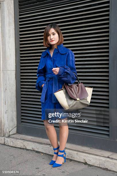 Fashion blogger Miu Pham wears a Xuan-Thu Nguyen coat, Laurence Dacade shoes and a Celine bag on day 3 of Paris Haute Couture Fashion Week...