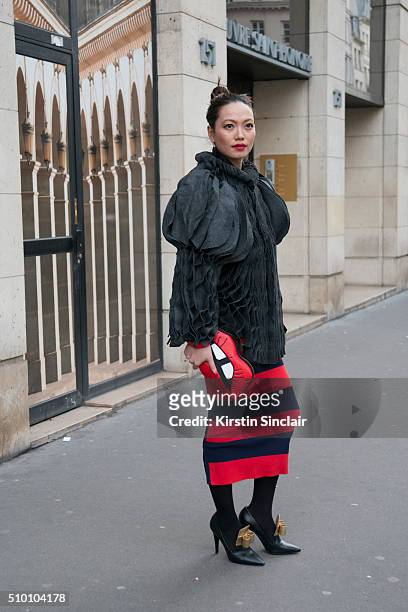 Head hunter and fashion blogger Thythu Nguyen wears a Xuan-Thu Nguyen jacket, Sonia Rykiel skirt, Skinny Dip London bag, and Laurence Dacade shoes on...
