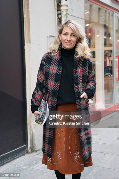 Ukraine representative of Buro 24/7 Asya Mkhytaryan wears a Prada bag, Miu Miu coat and Valentino skirt on day 3 of Paris Haute Couture Fashion Week...