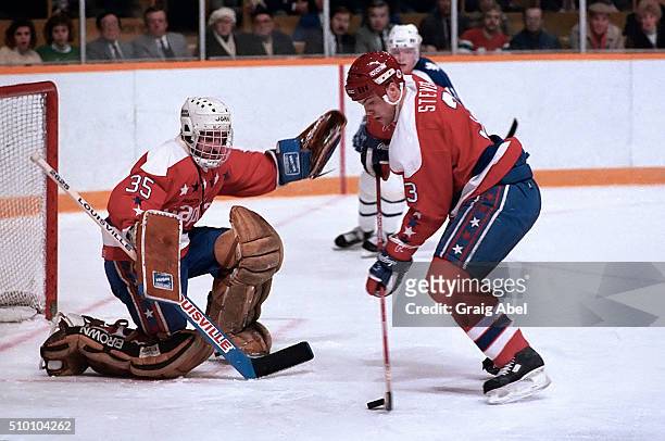 Scott Stevens clears the puck in front of team mate Al Jensen of the Washington Capitals during game action against the Toronto Maple Leafs at Maple...