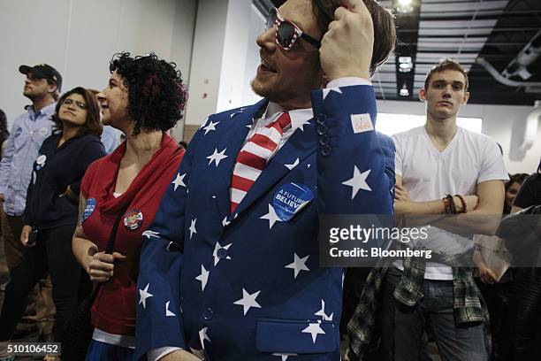 An attendee wears an American flag themed suit as he waits in line to enter a campaign event for Senator Bernie Sanders, an independent from Vermont...