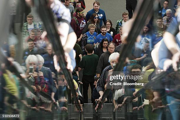 Attendees ride escalators as they enter a campaign event for Senator Bernie Sanders, an independent from Vermont and 2016 Democratic presidential...