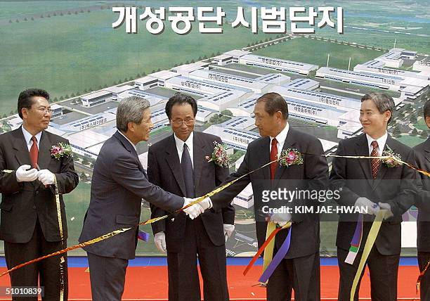 Hyundai Asan president Kim Yun-Kyu and Korea Land Corp. President Kim Jin-Ho ) of South Korea shake hands during a ground-breaking ceremony to build...