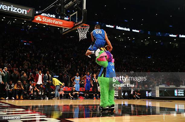 Aaron Gordon of the Orlando Magic dunks over Stuff the Orlando Magic mascot in the Verizon Slam Dunk Contest during NBA All-Star Weekend 2016 at Air...