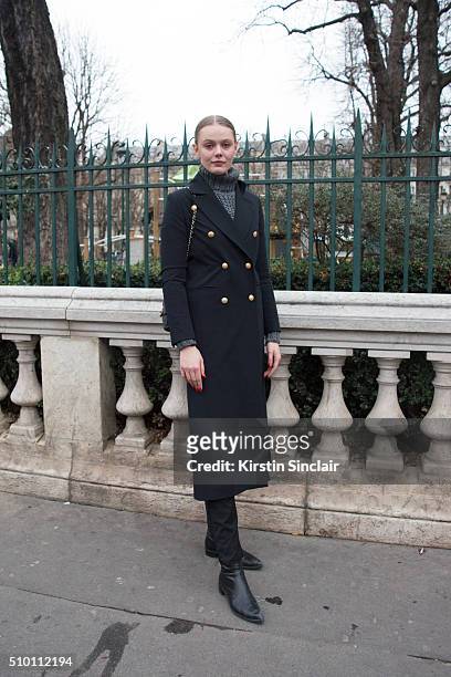 Model Frida Gustavsson wears a Hunky Dory coat, Blk Denim jeans, Saint Laurent boots and a Chanel bag on day 4 of Paris Haute Couture Fashion Week...