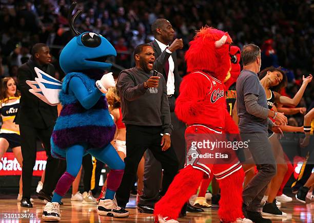 Actor Anthony Anderson, former NBA player Dikembe Mutombo and TV personality Jon Stewart dance on court with mascots in the Foot Locker Three-Point...