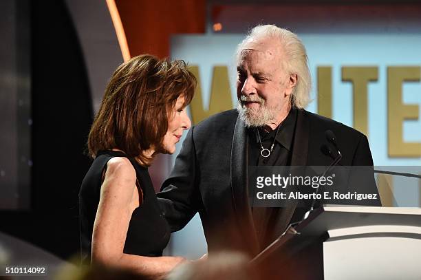 Writer/director Robert Towne presents the Screen Laurel Award to honoree Elaine May onstage during the 2016 Writers Guild Awards at the Hyatt Regency...