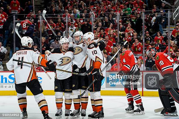 Ryan Getzlaf of the Anaheim Ducks celebrates with Sami Vatanen and Corey Perry after scoring the game winning goal in overtime, resulting in a 3 to 2...