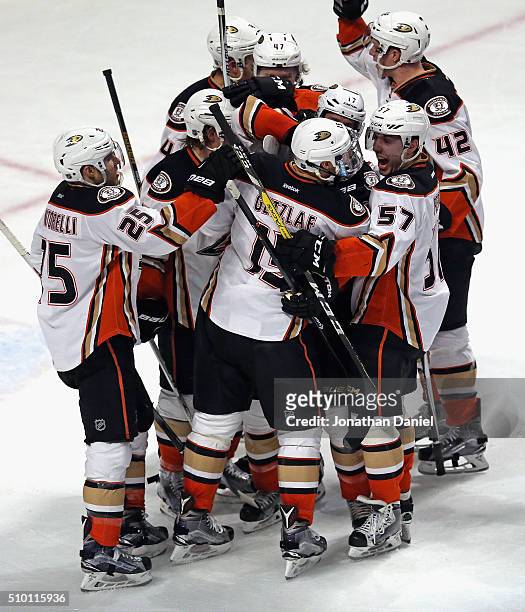 Members of the Anaheim Ducks including Mike Santorelli and David Perron mob Ryan Getzlaf after Getzlaf scored the game-winning goal in overtime...