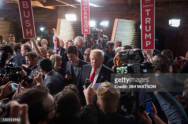 Republican presidential candidate Donald Trump talks with reporters in the Spin Room following the CBS News Republican Presidential Debate in...