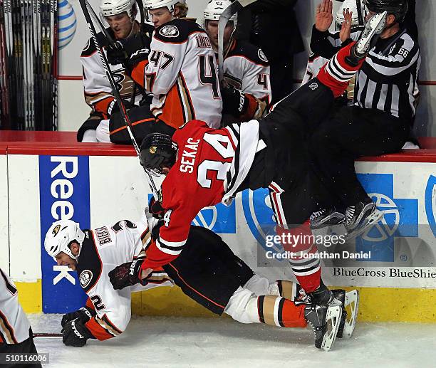 Jiri Sekac of the Chicago Blackhawks goes airborne after collding with Kevin Bieksa of the Anaheim Ducks at the United Center on February 13, 2016 in...