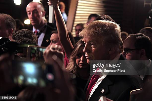 Presidential candidate Donald Trump speaks in the "Spin Room" following the Republican Presidential debate on February 13, 2016 in Greenville, South...