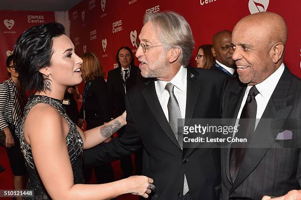 Recording artist Demi Lovato, Recording Academy and MusiCares President/CEO Neil Portnow and founder of Motown Records Berry Gordy attend the 2016...
