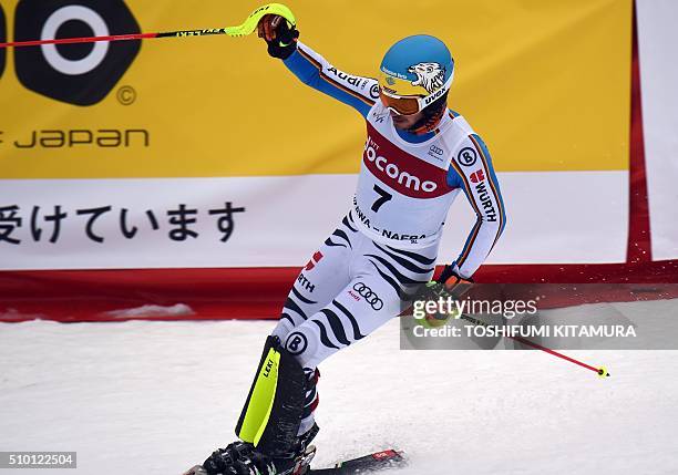 Felix Neureuter of Germany clinches his fist after crossing the finish line during his second run of the 8th men's slalom competition in the FIS Ski...