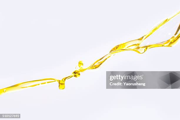 active oil splash in white background - olive oil splash stock pictures, royalty-free photos & images