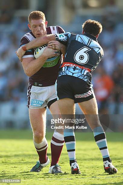 Tom Symonds of the Eagles is tackled by James Maloney of the Sharks during the NRL Trial match between the Cronulla Sharks and the Manly Sea Eagles...