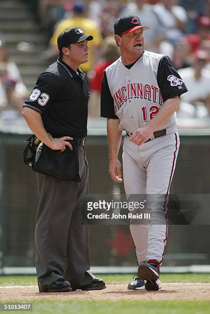 Manager Dave Miley of the Cincinnati Reds speaks with home plate umpire Matt Hollowell during the MLB game against the Cleveland Indians on June 13,...