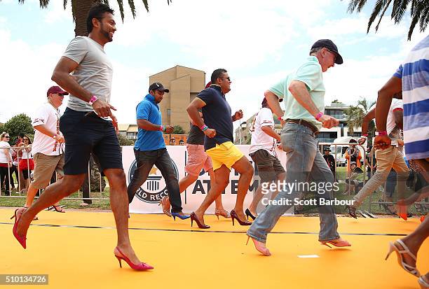 Men wearing high heeled shoes take part in a Guinness World Record attempt for the largest amount of people running in high heels on February 14,...