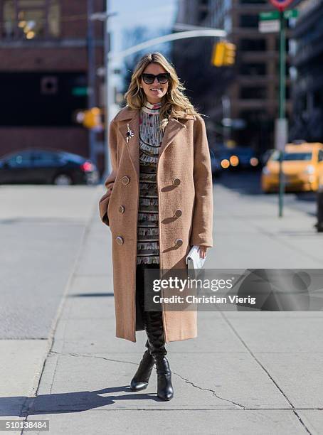 Brazilian fashion blogger Helena Bordon wearing a Zimmermann dress, a white Jimmy Choo clutch, a beige Animale Brasil wool coat, black Gianvito Rossi...