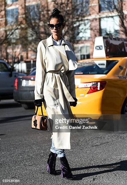Juana Burga is seen outside the Tibi show wearing a white coat during New York Fashion Week: Women's Fall/Winter 2016 on February 13, 2016 in New...