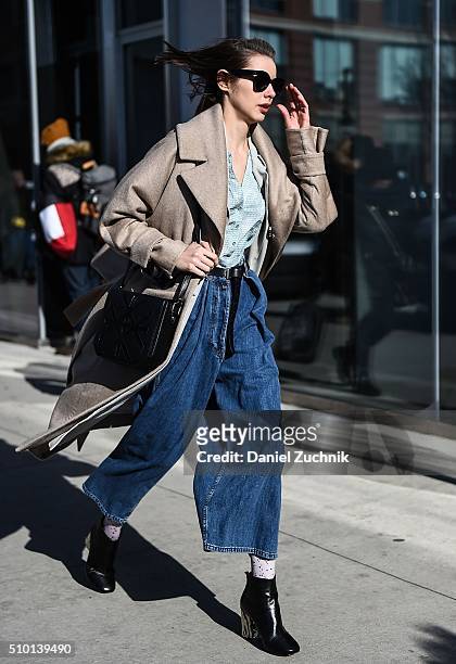 Marina Ingvarsson is seen outside the Tibi show wearing a Michelle Waughny brown overcoat, Noon by Noor coat, Lou and Grey top, Dries Van Noten blue...