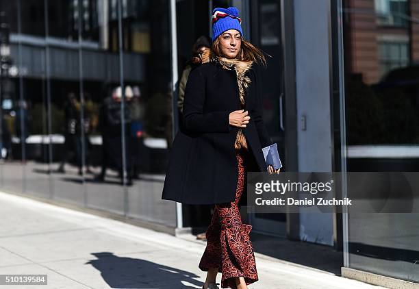 Ramya Giangola is seen outside the Tibi show wearing a Celine blue with fur trim coat and Golden Goose sneakers during New York Fashion Week: Women's...