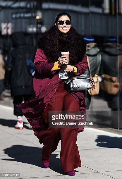 Caroline Issa is seen outside the Tibi show wearing a red jacket, red pants and a black scarf during New York Fashion Week: Women's Fall/Winter 2016...