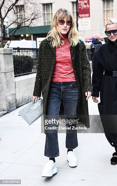 Annabel Rosendahl is seen outside the Alexander Wang show wearing a forest green coat with blue jeans, white shoes and red sweater during New York...