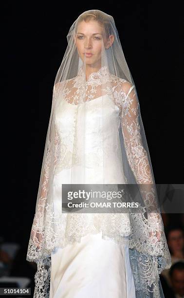 Model displays a wedding dress by Spanish designer Rosa Clara, as part of a show of Spanish designers in Mexico City 30 June 2004. AFP PHOTO/ Omar...