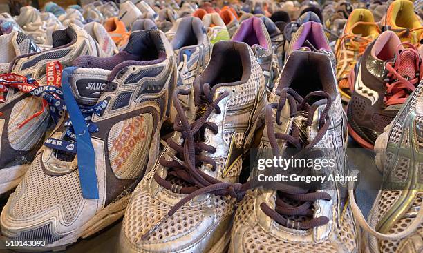 Running shoe memorial to the victims of the 2013 Boston Marathon bombing. The words "Boston Strong" are written on the side of one of the shoes.