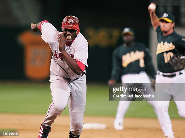 Vladimir Guerrero of the Anaheim Angels is caught in a run-down after over-running first base on a single as Scott Hatteberg of the Oakland Athletics...