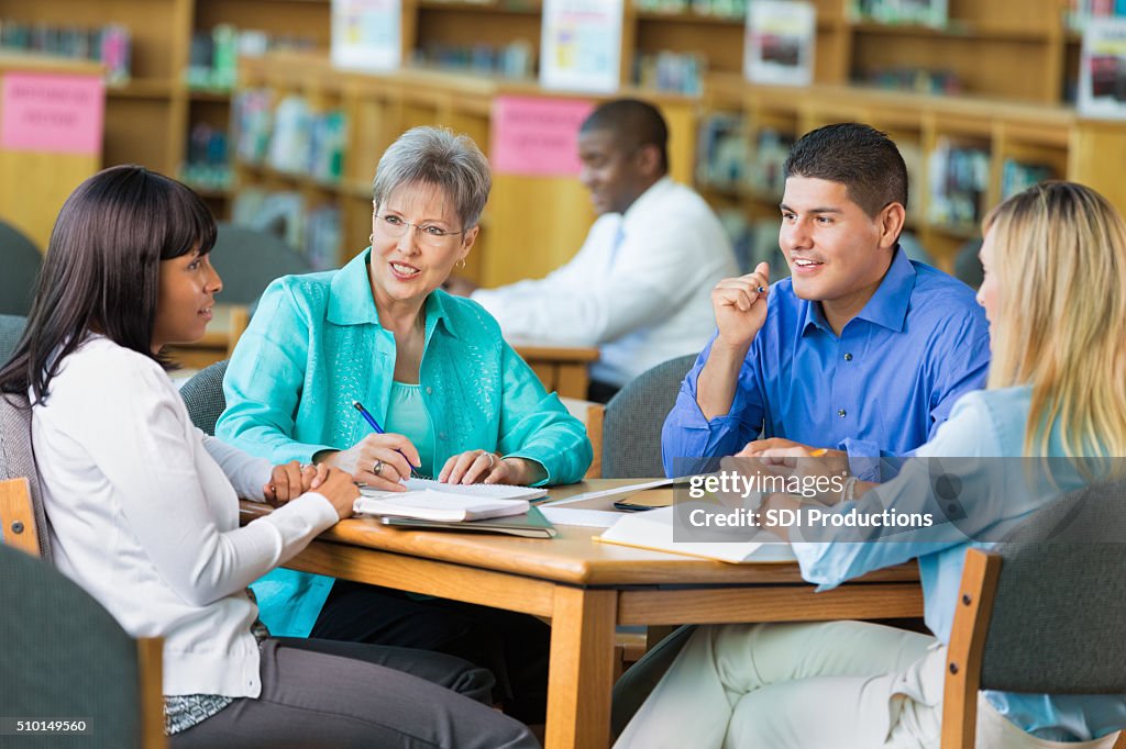 Group of teachers meet in library