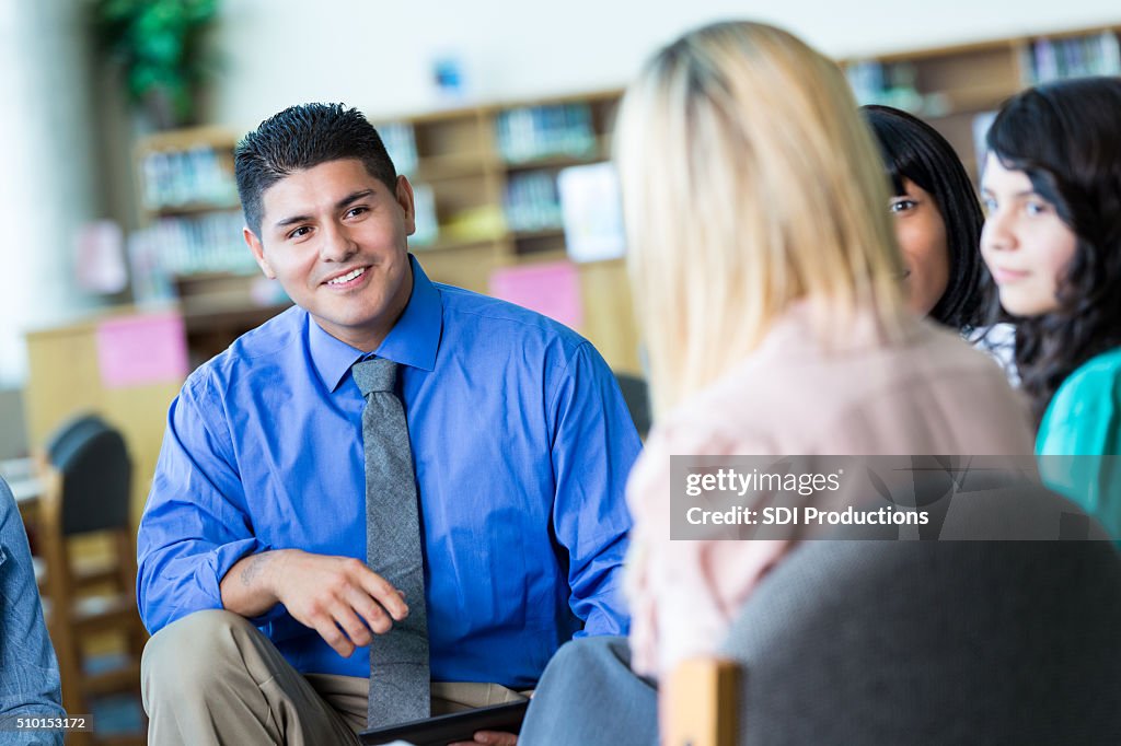 Teacher or principal meets with parents and students