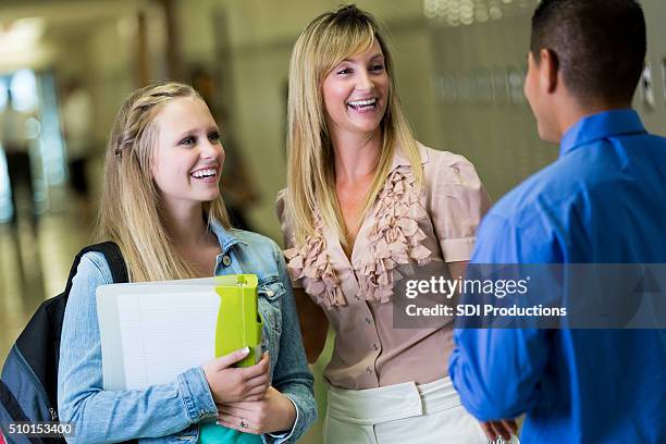 high school student and her mother talk with school principal - teacher with folder stock pictures, royalty-free photos & images