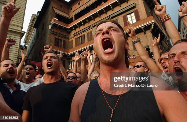 Contradaioli belonging to the Torre neighbourhood intone ritual chants as they follow their horse to Piazza del Campo before the start of one of the...