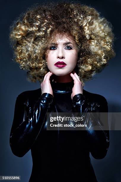 fashionable and cool woman in latex suit - saucy ladies stock pictures, royalty-free photos & images