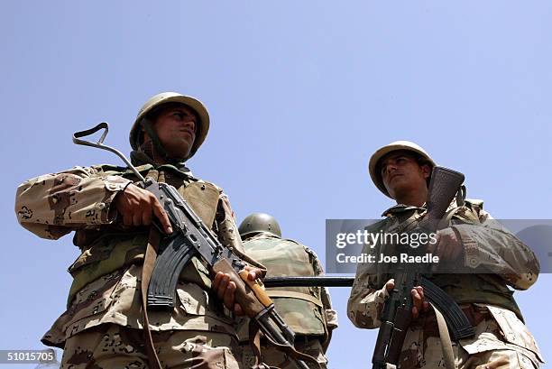 Iraqi Civil Defense Corps members patrol July 1, 2004 in Baghdad