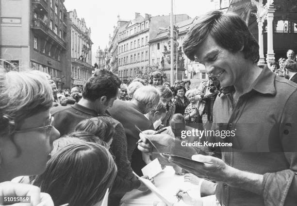 American film actor Dean Reed signs autographs for fans in Czechoslovakia, circa 1976. Reed's left-wing political views led to settle in East Germany...