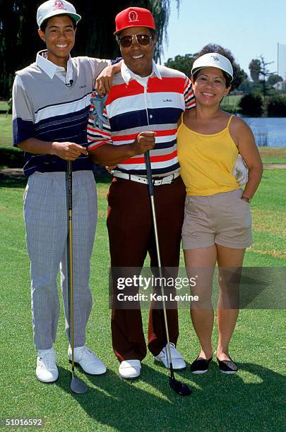 Golfer Tiger Woods poses for a photograph with his mother and father Earl and Kultida Woods on September 22, 1990.