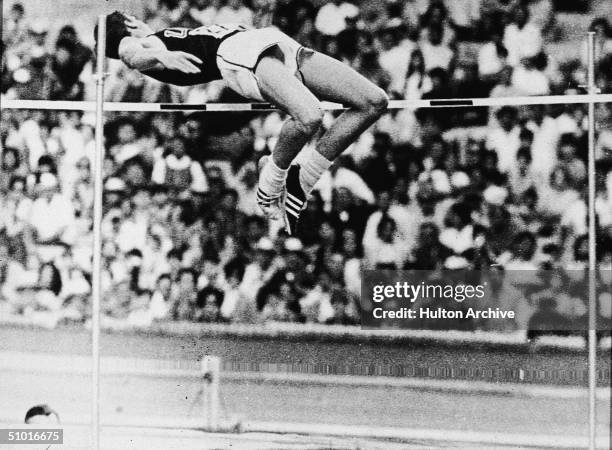 American high jumper Dick Fosbury clears the bar and sets an Olympic record of 7 - 4 1/4, Mexico City, Mexico, late October 1968. His technique,...