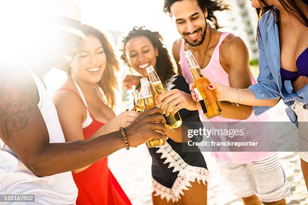 beach party - lens flare young people dancing on beach stock pictures, royalty-free photos & images