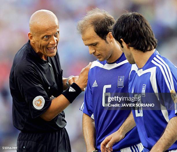 Italian referee Pierluigi Collina talks to Greece's midfielder Angelis Basinas , 01 July 2004 at Dragao stadium in Porto, during the Euro 2004...