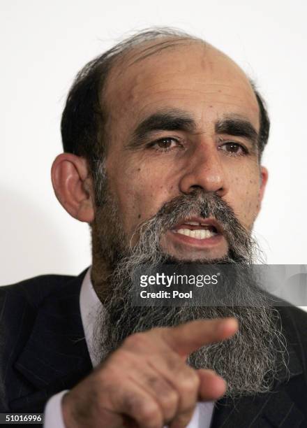 Former Saddam Hussein Lieutenant Abid Hamid Mahmud al-Khatab listens as a list of charges that he along with 10 other high level defendents and...