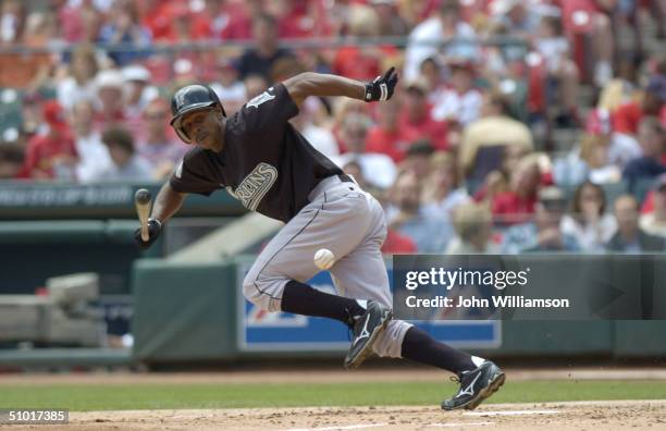 Center fielder Juan Pierre of the Florida Marlins eyes the ball as he runs to first base during the MLB game against the St. Louis Cardinals at Busch...