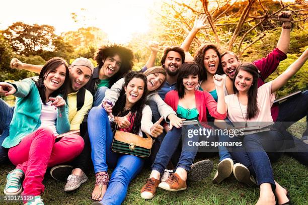 multi-ethnic group of young students having fun at university campus - student visa stockfoto's en -beelden