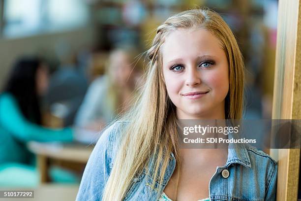 pretty high school girl in school library - blonde hair girl stock pictures, royalty-free photos & images