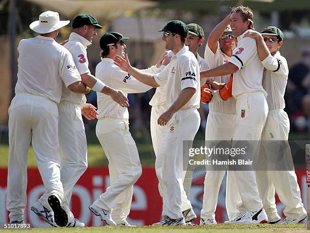 Glenn McGrath of Australia celebrates his fifth wicket with team mates of Russel Arnold of Sri Lanka during day two of the First Test between...