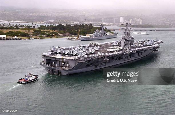 In this handout image provided by the U.S. Navy, U.S. Sailors "man the rails" aboard the Nimitz-class aircraft carrier USS John C. Stennis as she...